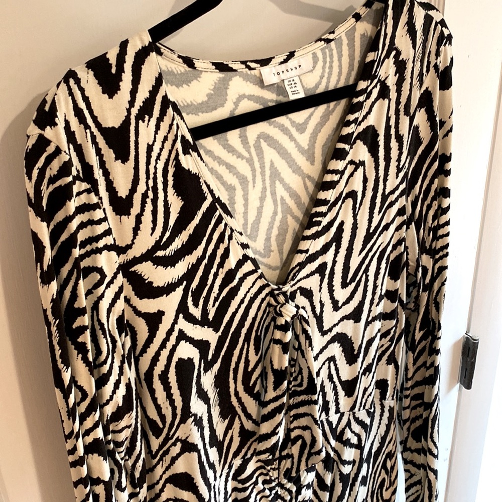 Form fitting, patterned dress with slit in front and long sleeves